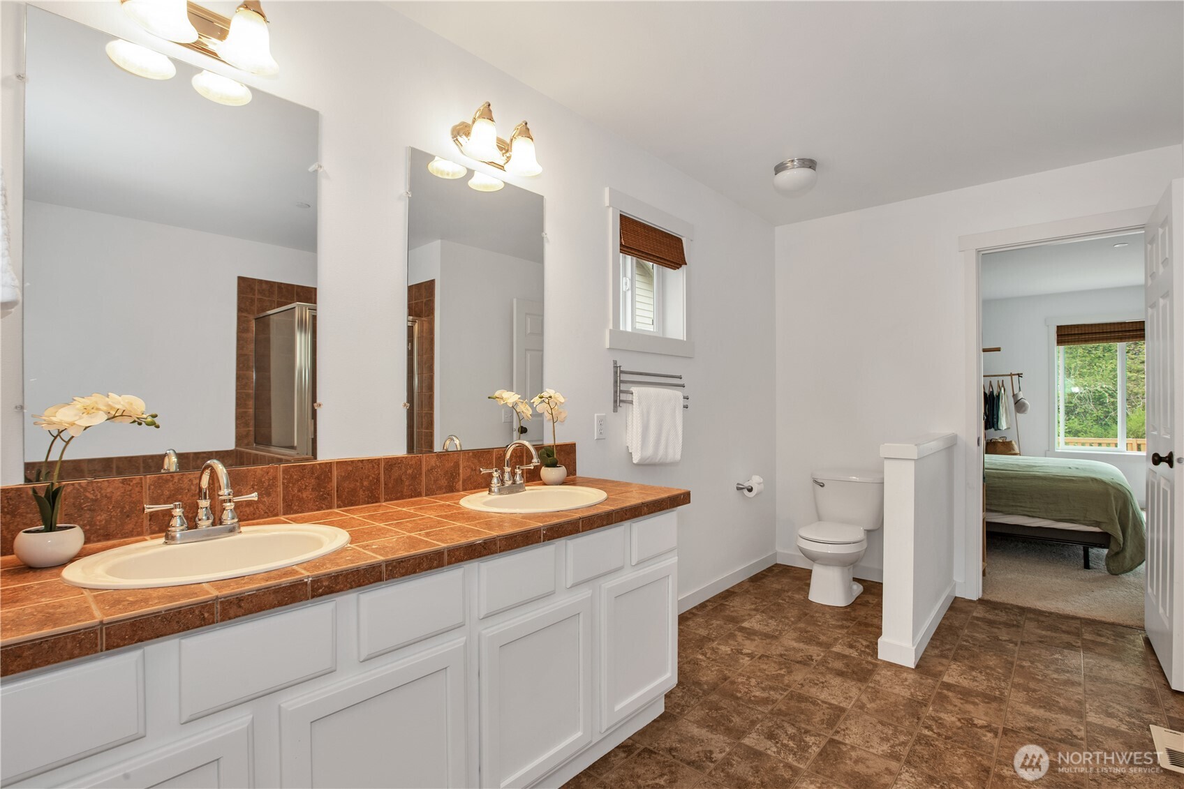 1344 Foreman Road DuPont, WA 98327 - Photo 34 of 40 a spacious bathroom with a double vanity sink a mirror and a toilet