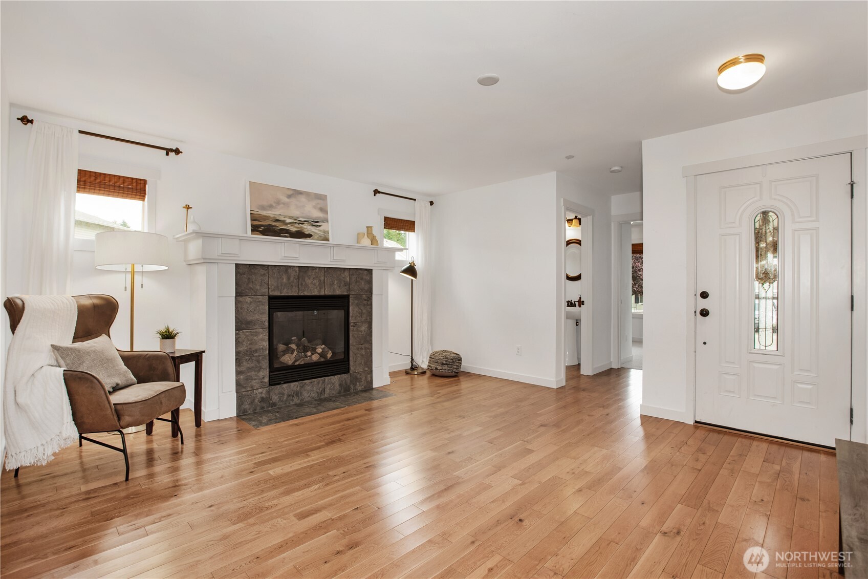 1344 Foreman Road DuPont, WA 98327 - Photo 4 of 40 a view of a livingroom with wooden floor and a fireplace