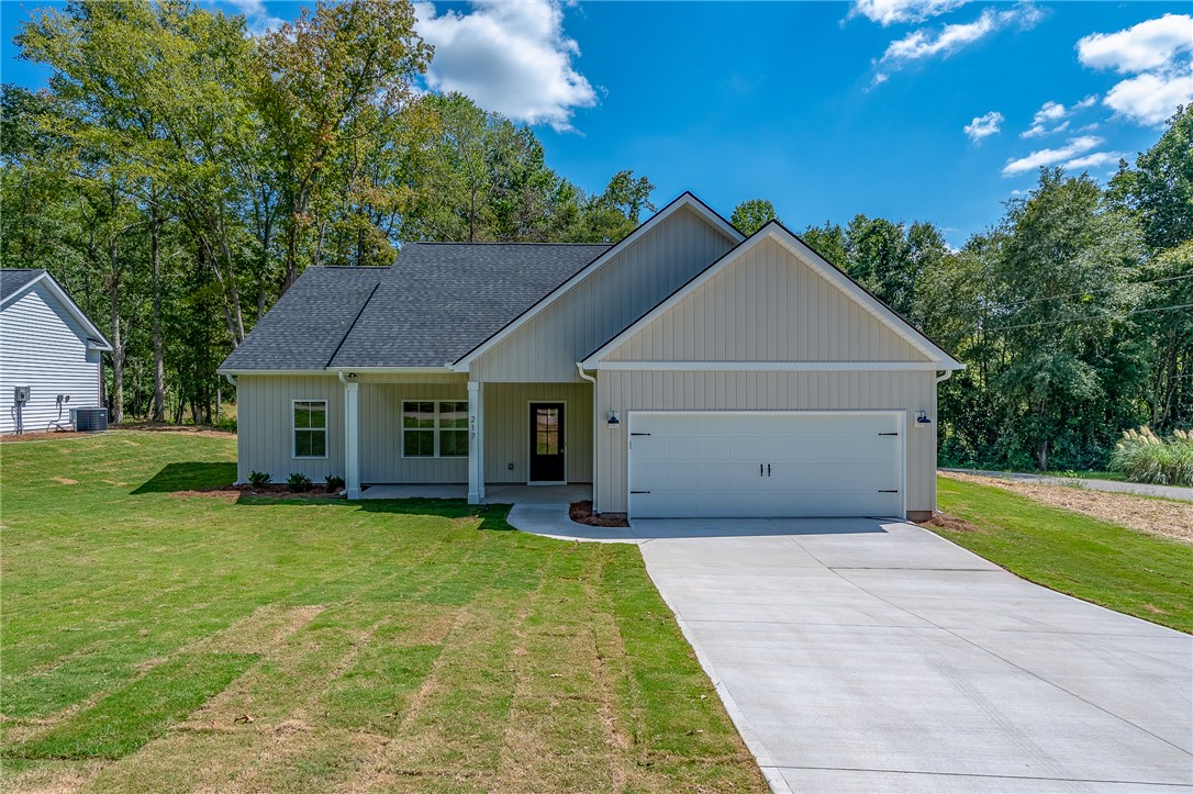 This charming home offers curb appeal and a convenient attached garage, ideal for comfortable living.