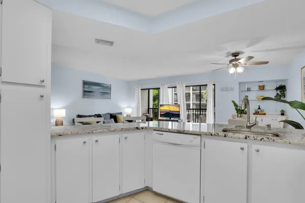 a kitchen with sink cabinets and stove