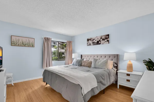a bedroom with a large bed and a window