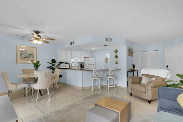 a living room with furniture and view of kitchen