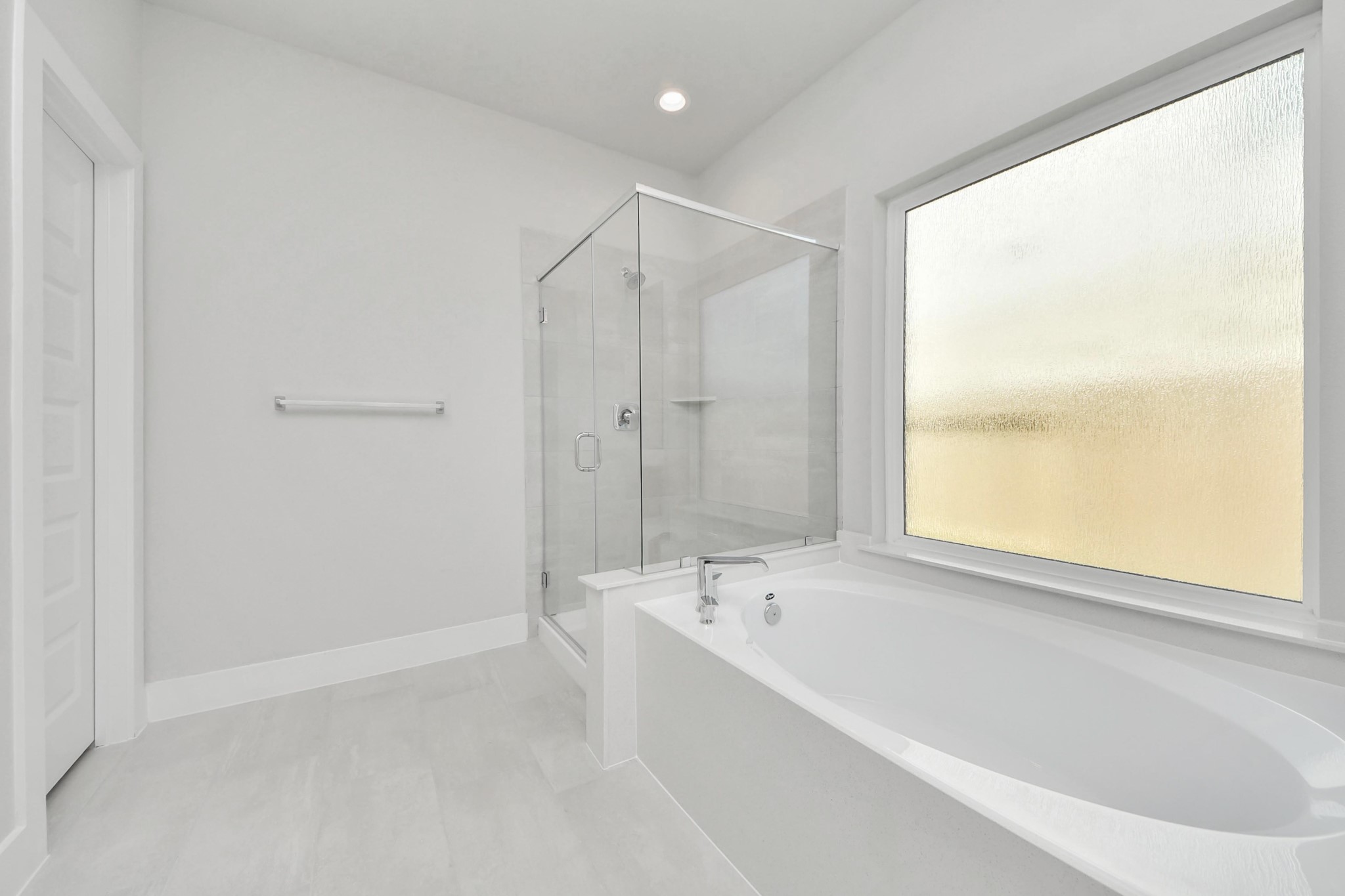 3042 Native Spg Drive Spring, TX 77373 - Photo 26 of 32 Indulge in a spa-like retreat within the confines of this primary bathroom. Delight in a spacious walk-in shower enveloped in stylish tile surround, unwind in a separate garden tub adorned with custom detailing. Sample photo of completed home with similar floor plan. Actual colors and selections may vary.