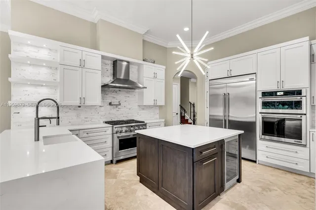 a kitchen with stainless steel appliances a sink and a stove