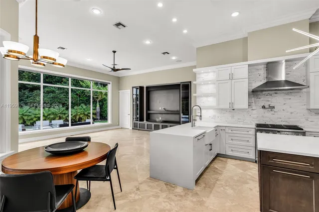 a kitchen with stainless steel appliances a stove a sink and a refrigerator