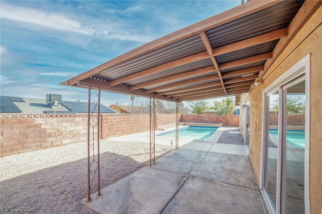 3556 Ruth Drive Las Vegas, NV 89121 - Photo 17 of 21 A spacious covered patio overlooks the crystal-clear private pool, ideal for outdoor leisure.