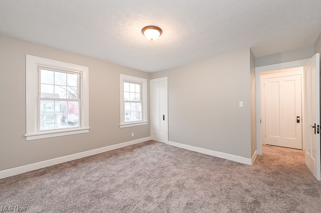 3379 Cedarbrook Road Cleveland, OH 44118 - Photo 19 of 31 Unfurnished room featuring light carpet and a textured ceiling