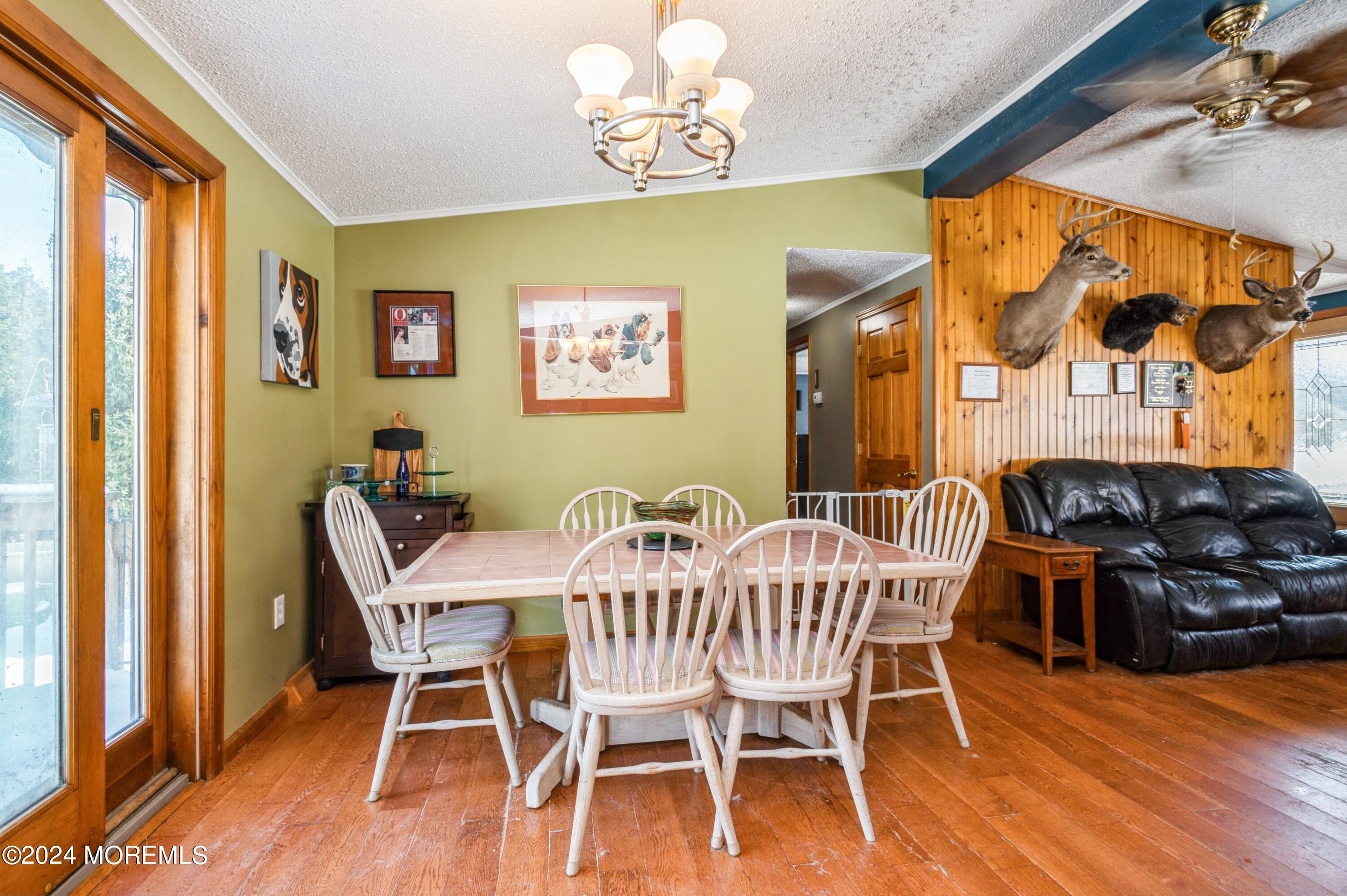 151 Cassville Road Jackson, NJ 08527 - Photo 12 of 14 a view of a dining room with furniture a chandelier and wooden floor