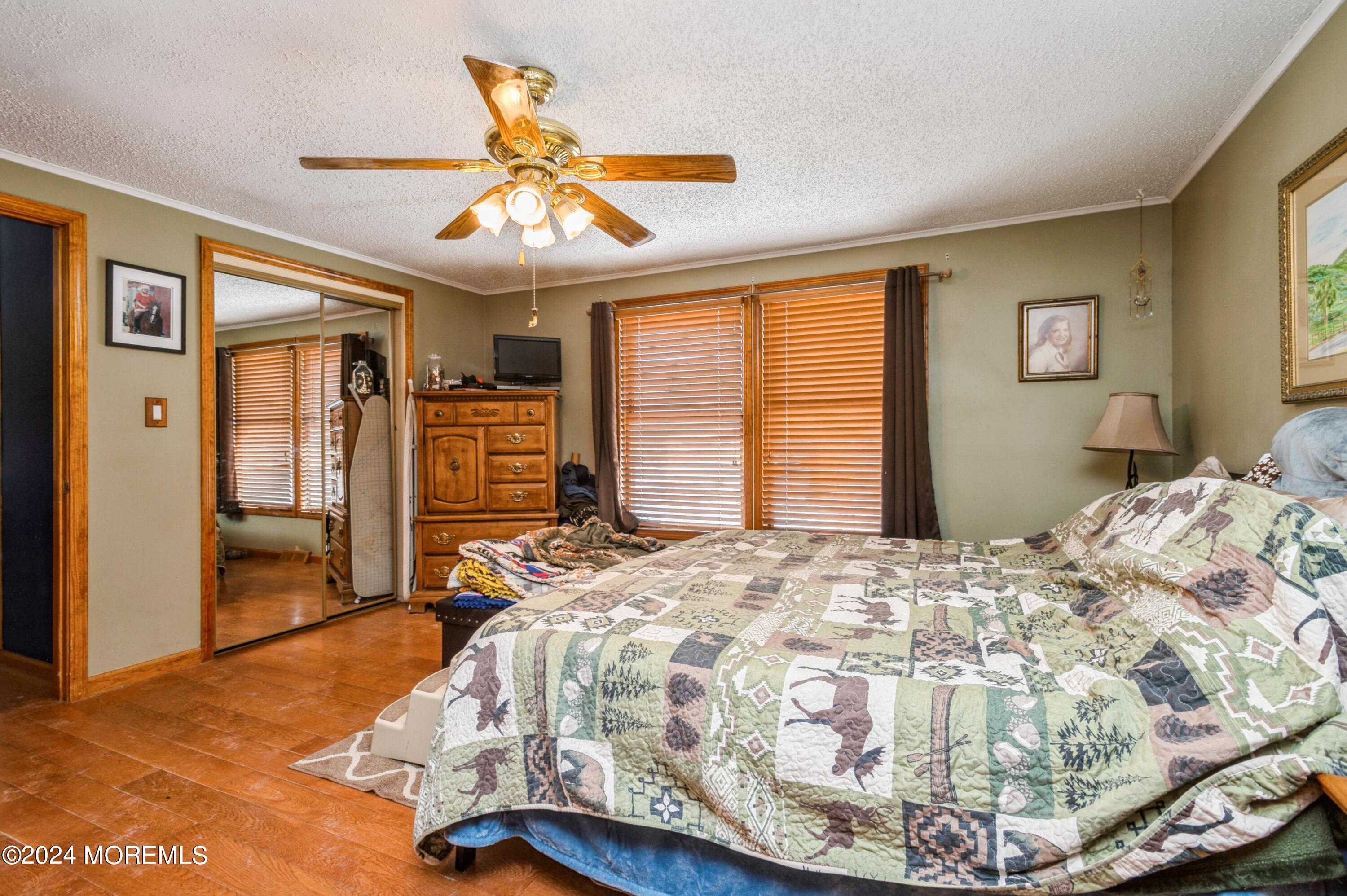 151 Cassville Road Jackson, NJ 08527 - Photo 13 of 14 a bedroom with a bed and a chandelier