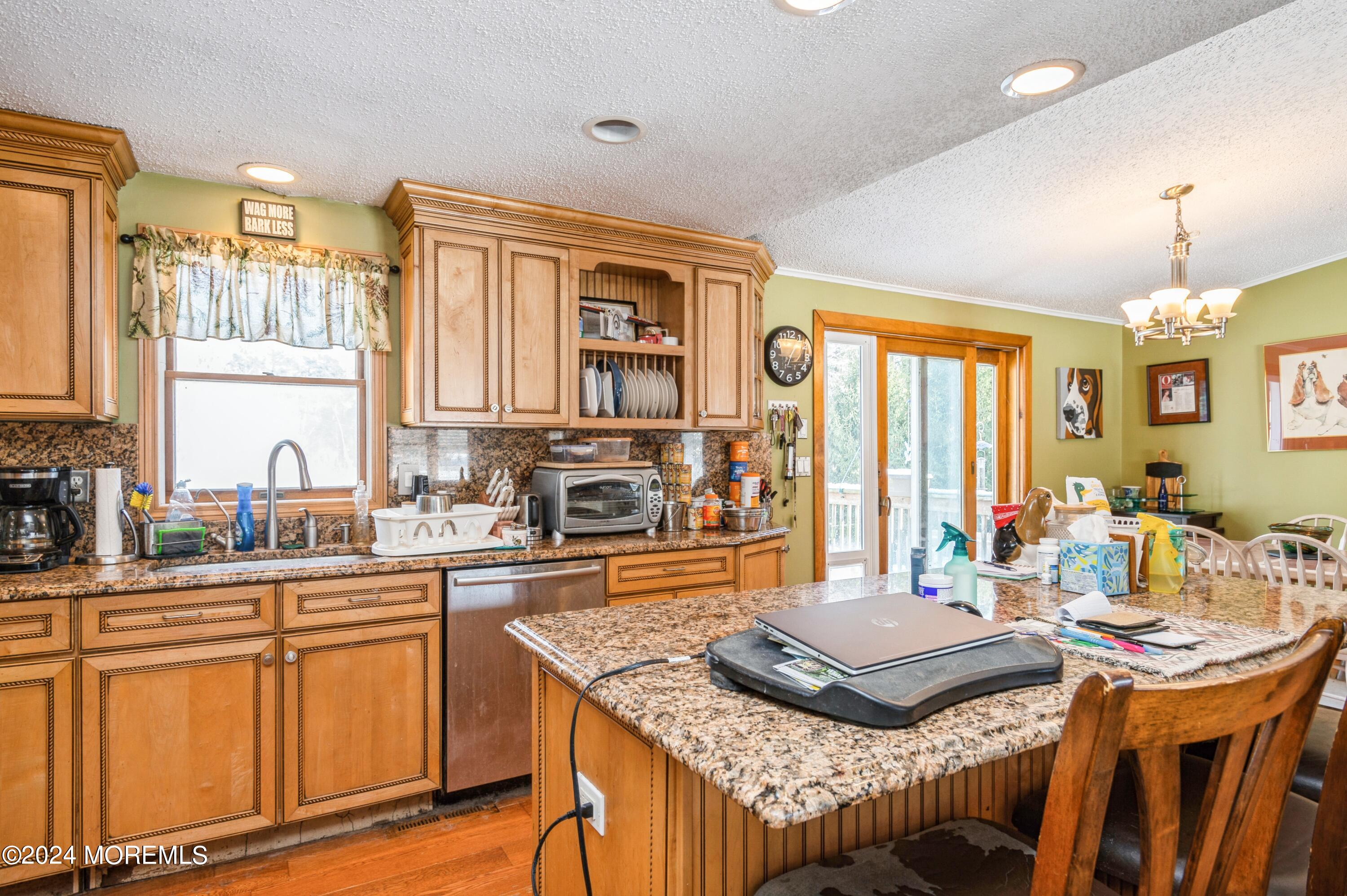 151 Cassville Road Jackson, NJ 08527 - Photo 9 of 14 a kitchen with stainless steel appliances granite countertop a stove a sink dishwasher and cabinets with wooden floor