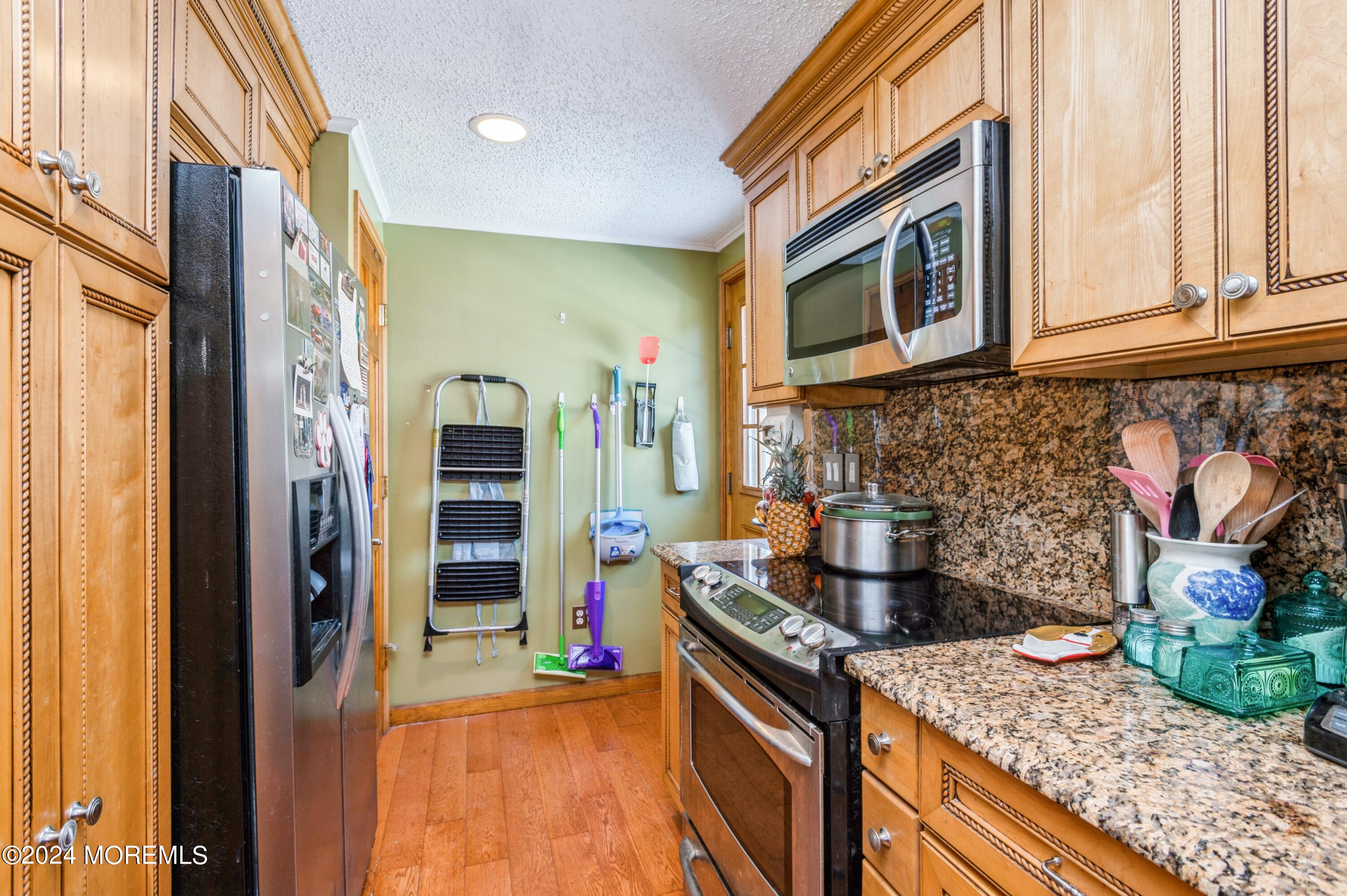 151 Cassville Road Jackson, NJ 08527 - Photo 10 of 14 a kitchen with stainless steel appliances granite countertop a stove and a sink