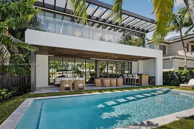 a view of a house with a yard balcony and swimming pool