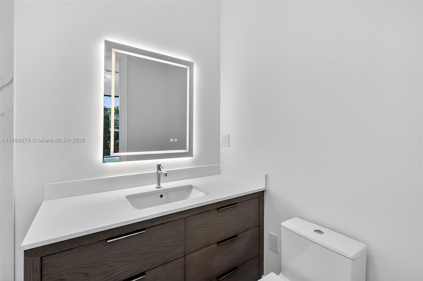 620 Solar Isle Drive Fort Lauderdale, FL 33301 - Photo 21 of 83 a bathroom with a sink a toilet and a mirror