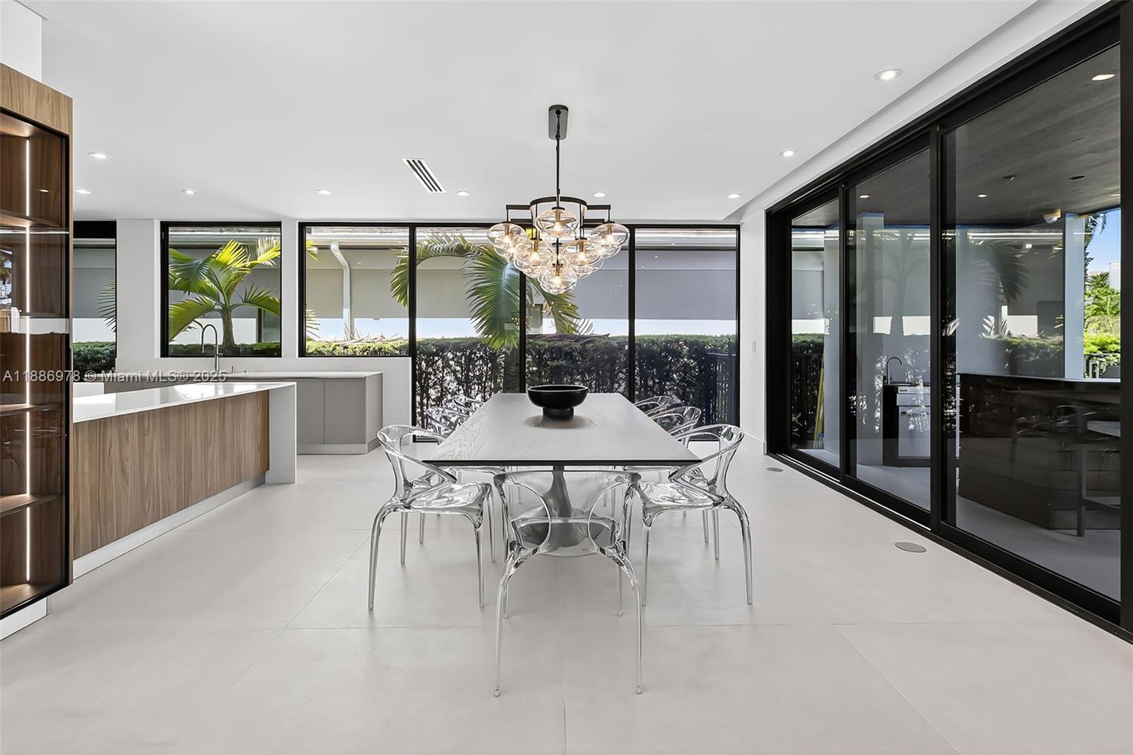 620 Solar Isle Drive Fort Lauderdale, FL 33301 - Photo 28 of 83 a dining room with furniture a chandelier and wooden floor