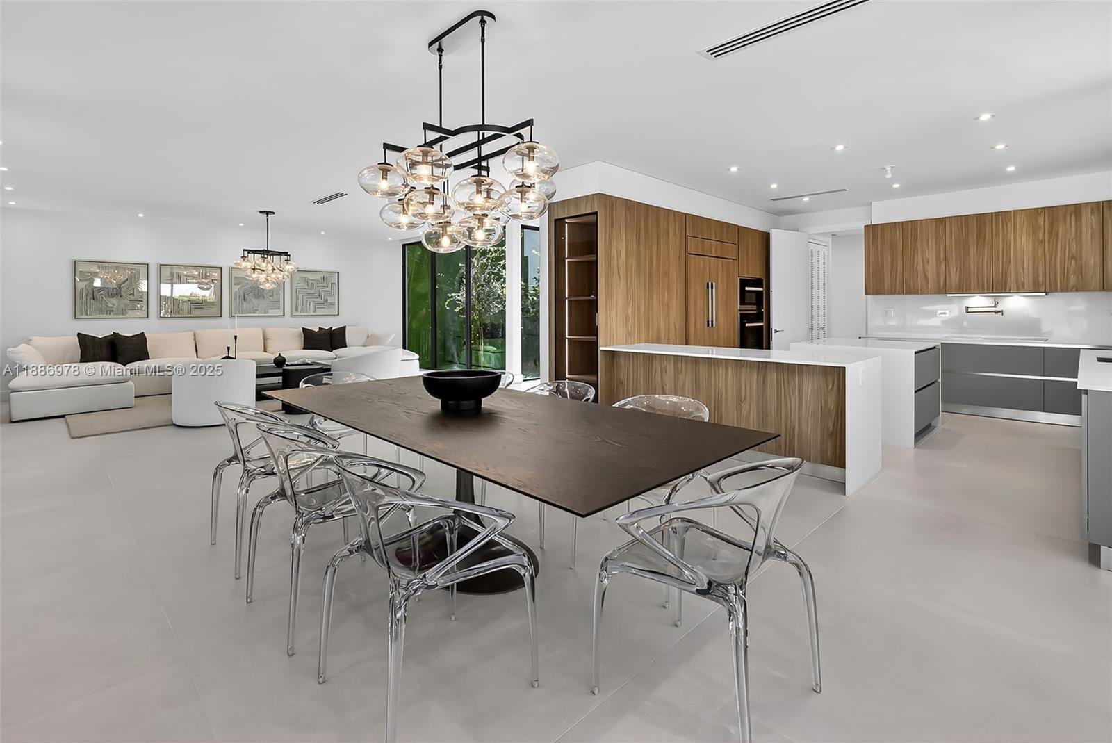 620 Solar Isle Drive Fort Lauderdale, FL 33301 - Photo 31 of 83 a view of a dining room and livingroom with furniture wooden floor a chandelier