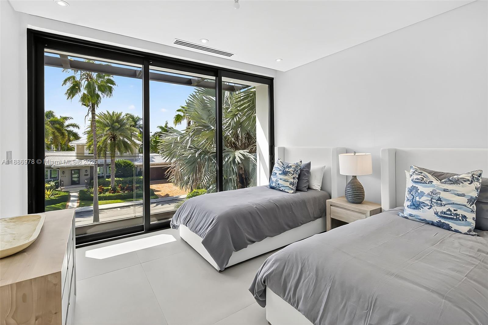 620 Solar Isle Drive Fort Lauderdale, FL 33301 - Photo 56 of 83 a bedroom with two beds and a large window