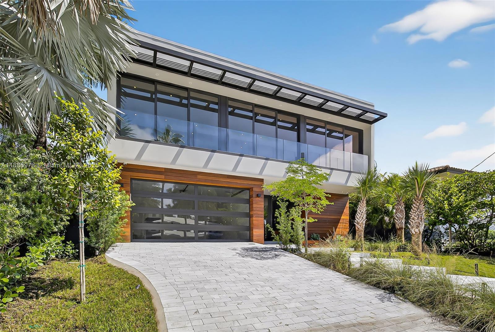 620 Solar Isle Drive Fort Lauderdale, FL 33301 - Photo 6 of 83 a front view of a house with a yard garage and outdoor seating