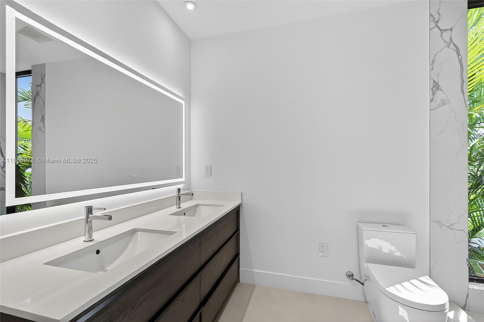 620 Solar Isle Drive Fort Lauderdale, FL 33301 - Photo 64 of 83 a bathroom with a sink a toilet and a mirror