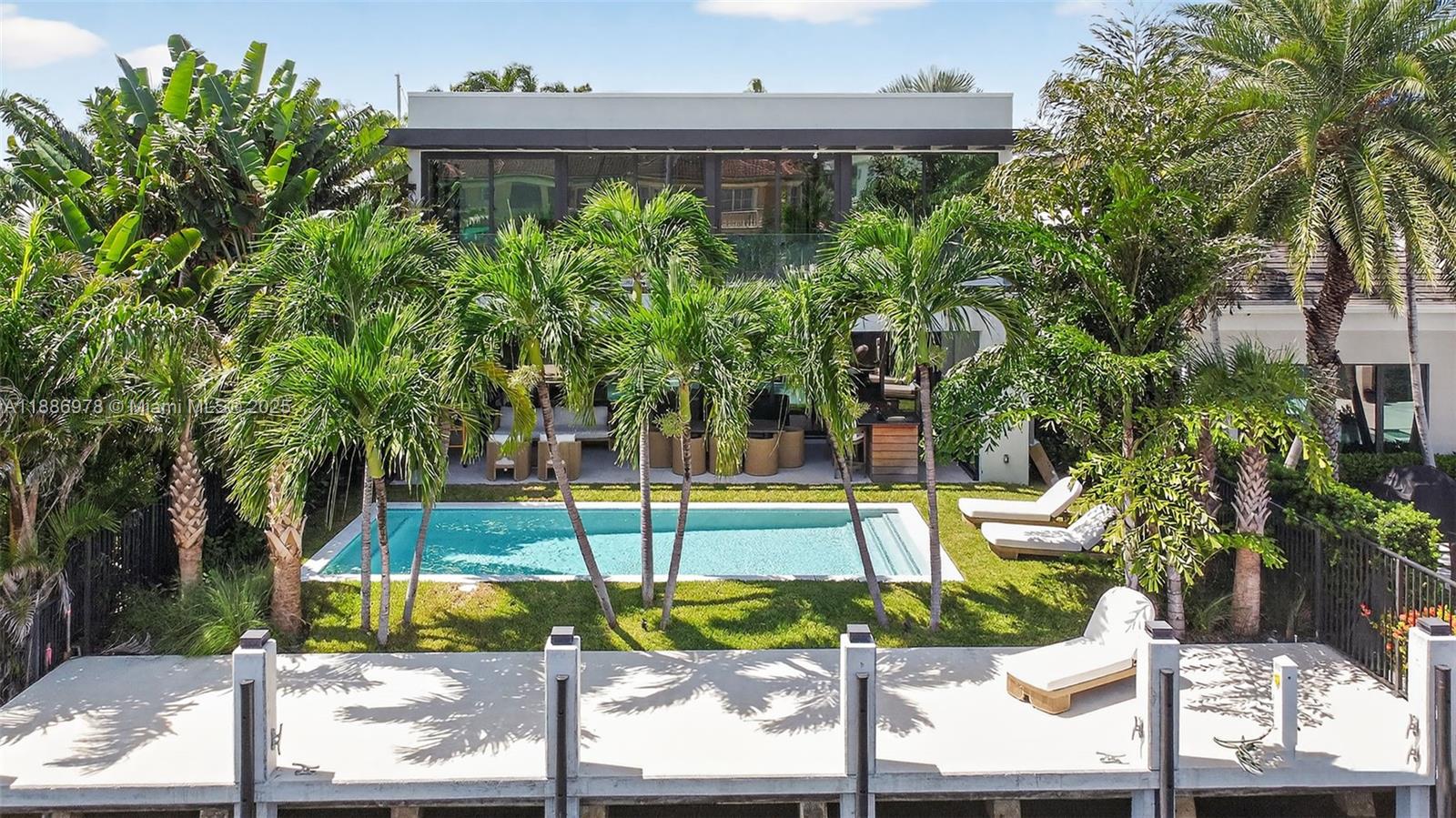 620 Solar Isle Drive Fort Lauderdale, FL 33301 - Photo 76 of 83 a view of a backyard house with large trees and plants