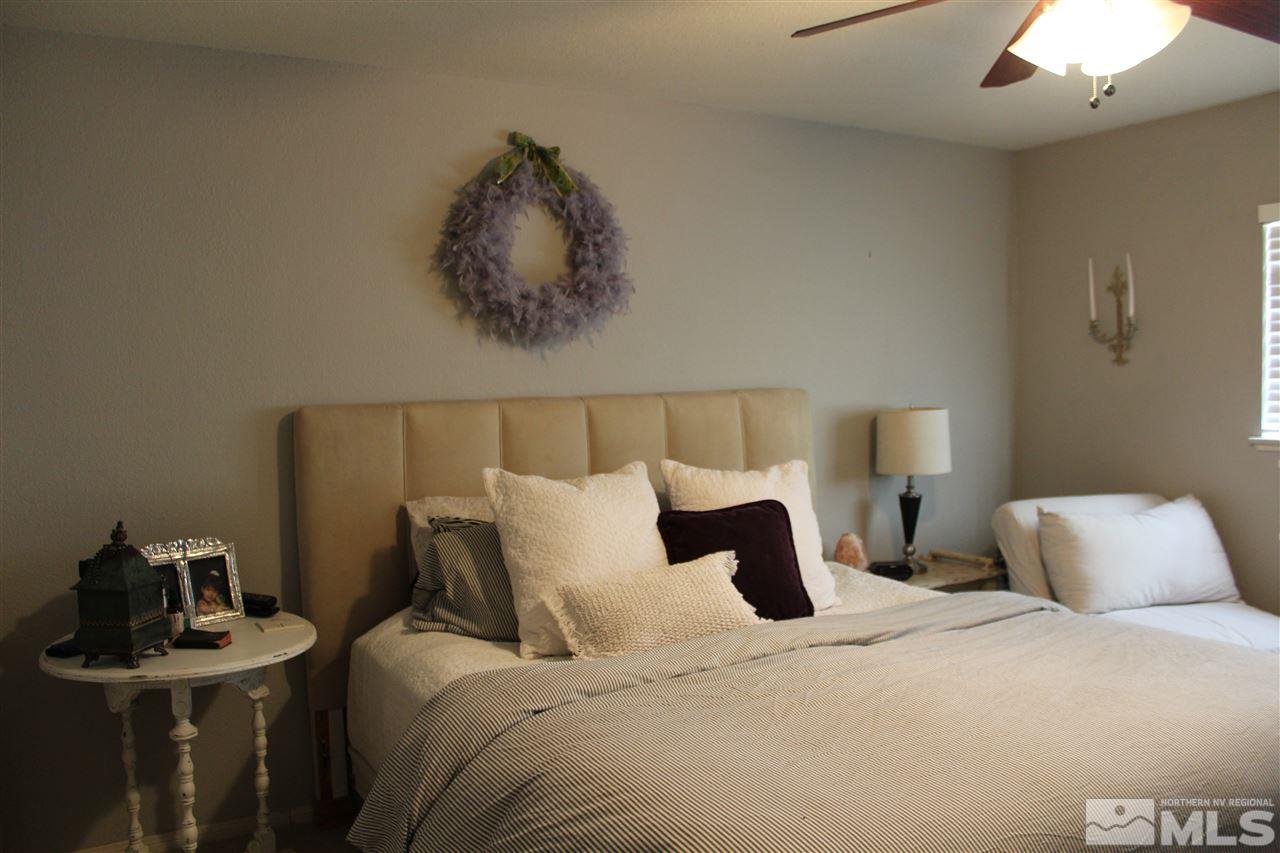 526 Citadel Road Reno, NV 89503 - Photo 12 of 22 a bedroom with a bed and a chandelier