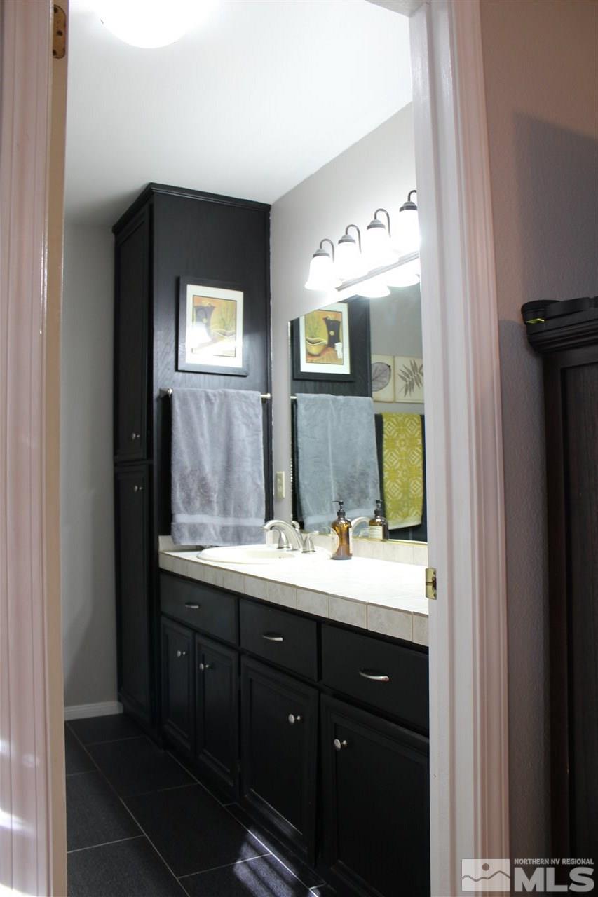 526 Citadel Road Reno, NV 89503 - Photo 13 of 22 a bathroom with a double vanity sink and mirror