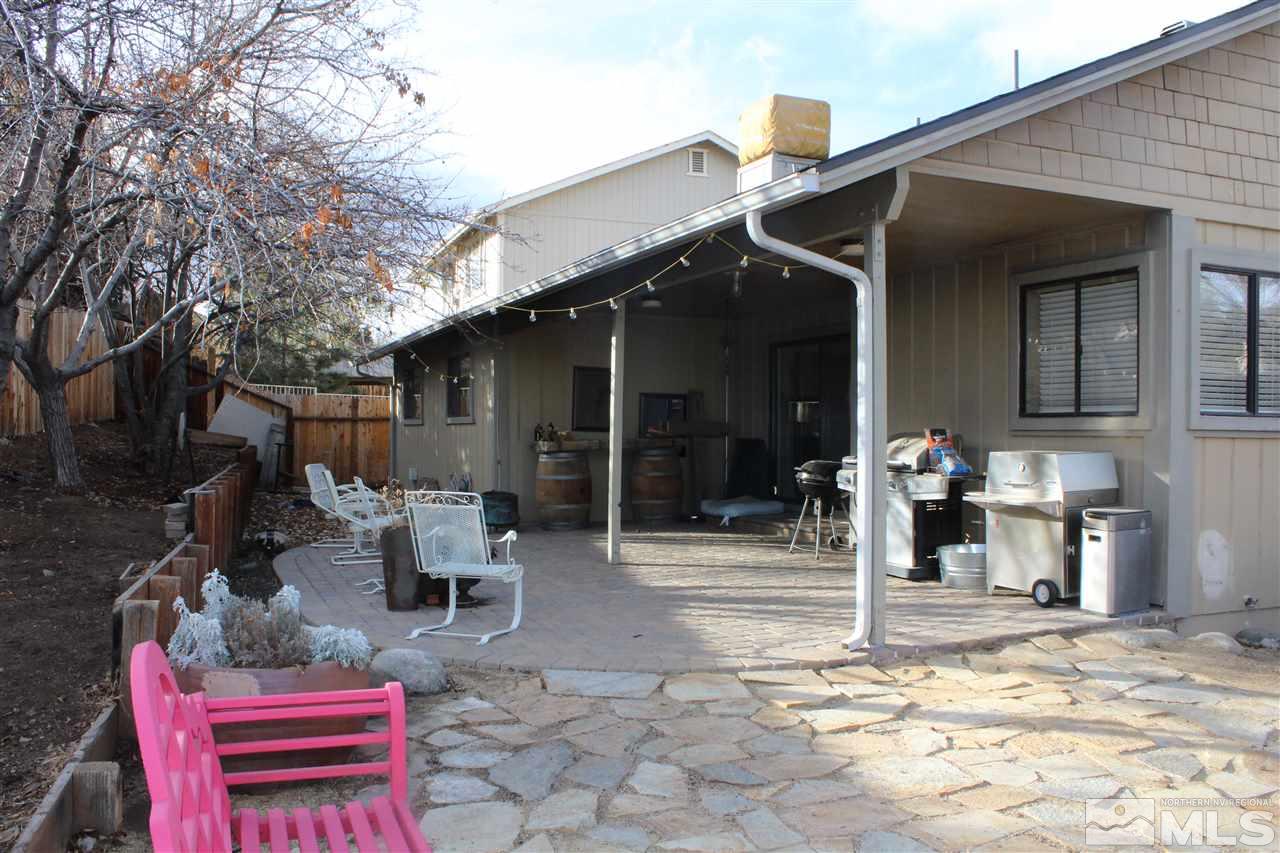 526 Citadel Road Reno, NV 89503 - Photo 19 of 22 a backyard of a house with barbeque oven table and chairs