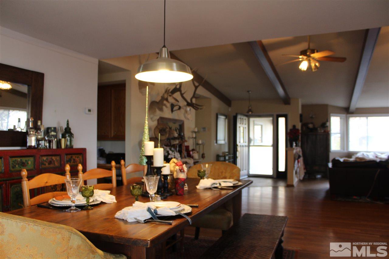 526 Citadel Road Reno, NV 89503 - Photo 6 of 22 a dining room with wooden floor a chandelier a glass table and chairs