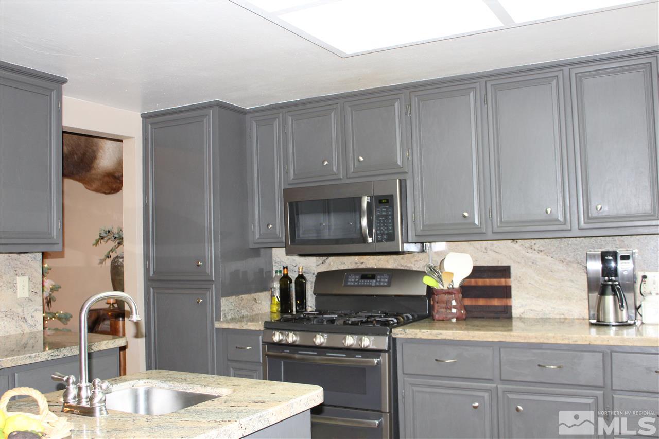 526 Citadel Road Reno, NV 89503 - Photo 10 of 22 a kitchen with granite countertop a sink stove and cabinets