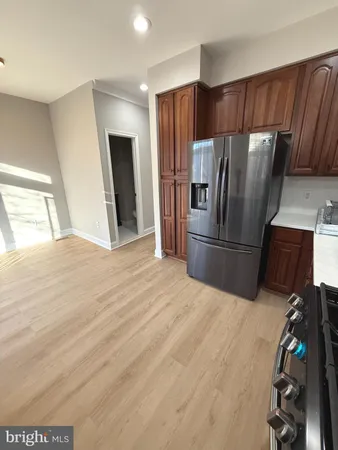 a kitchen with granite countertop a refrigerator and a sink