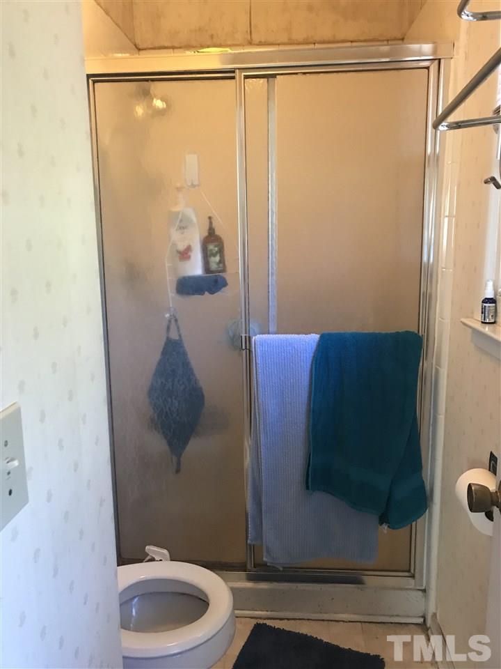 5908 Periwinkle Court Raleigh, NC 27609 - Photo 6 of 6 a bathroom with a shower and a sink