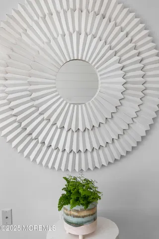 a kitchen with stainless steel appliances a dining table chairs refrigerator and microwave