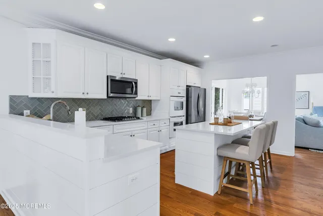 a living room with furniture flowerpot and wooden floor