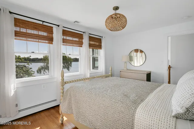 a bedroom with two beds and painting on the wall