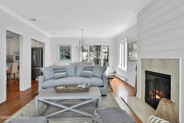 a living room with a couch and a chandelier