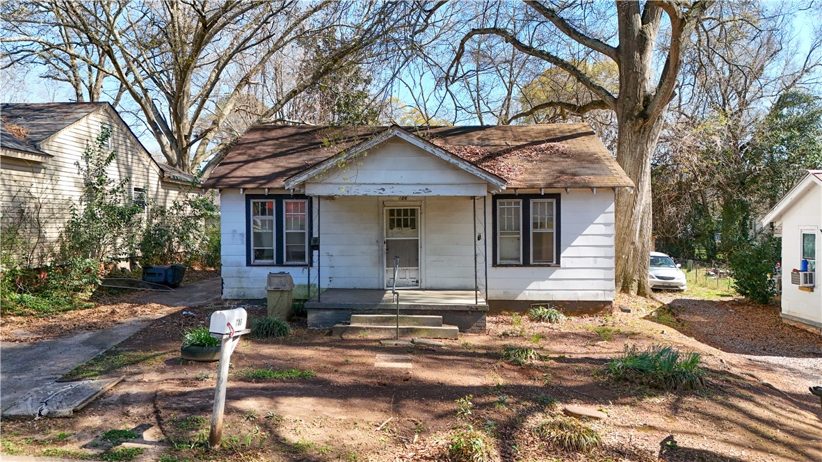 106 Frances Street Anderson, SC 29621 - Photo 3 of 15 Charming cottage with a welcoming porch and mature trees for shade.