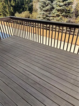 a bathroom with a granite countertop toilet and a sink