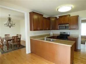a view of a kitchen with a sink stainless steel appliances and cabinets