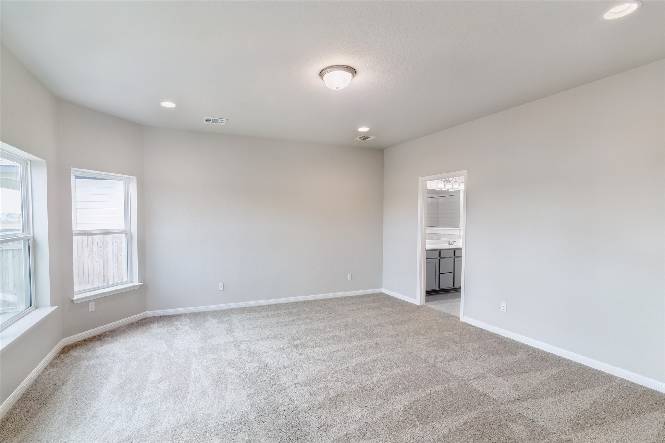 113 Watercourse Way Bastrop, TX 78602 - Photo 15 of 32 wooden floor in an empty room with a window