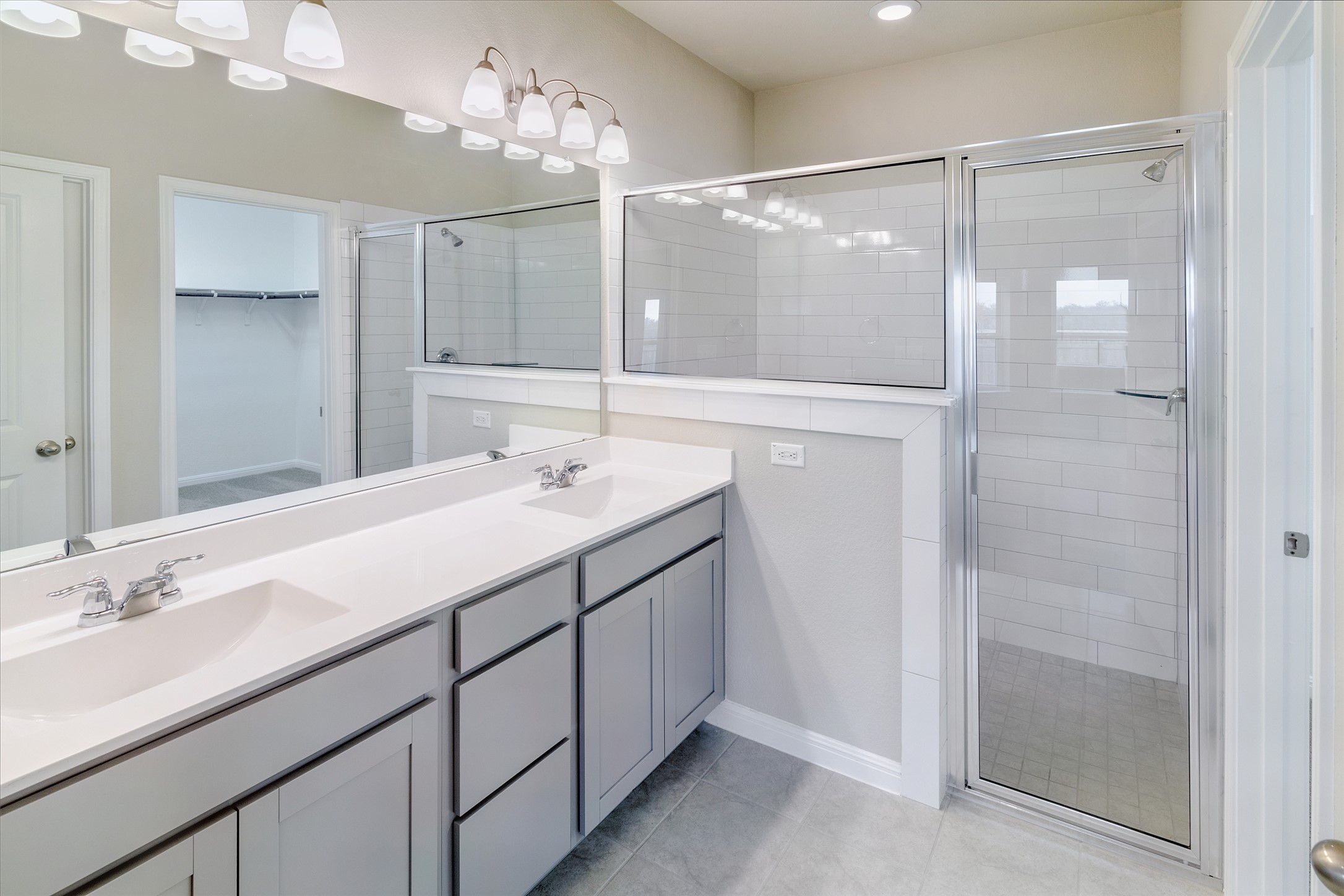 113 Watercourse Way Bastrop, TX 78602 - Photo 17 of 32 a bathroom with a double vanity sink mirror and shower