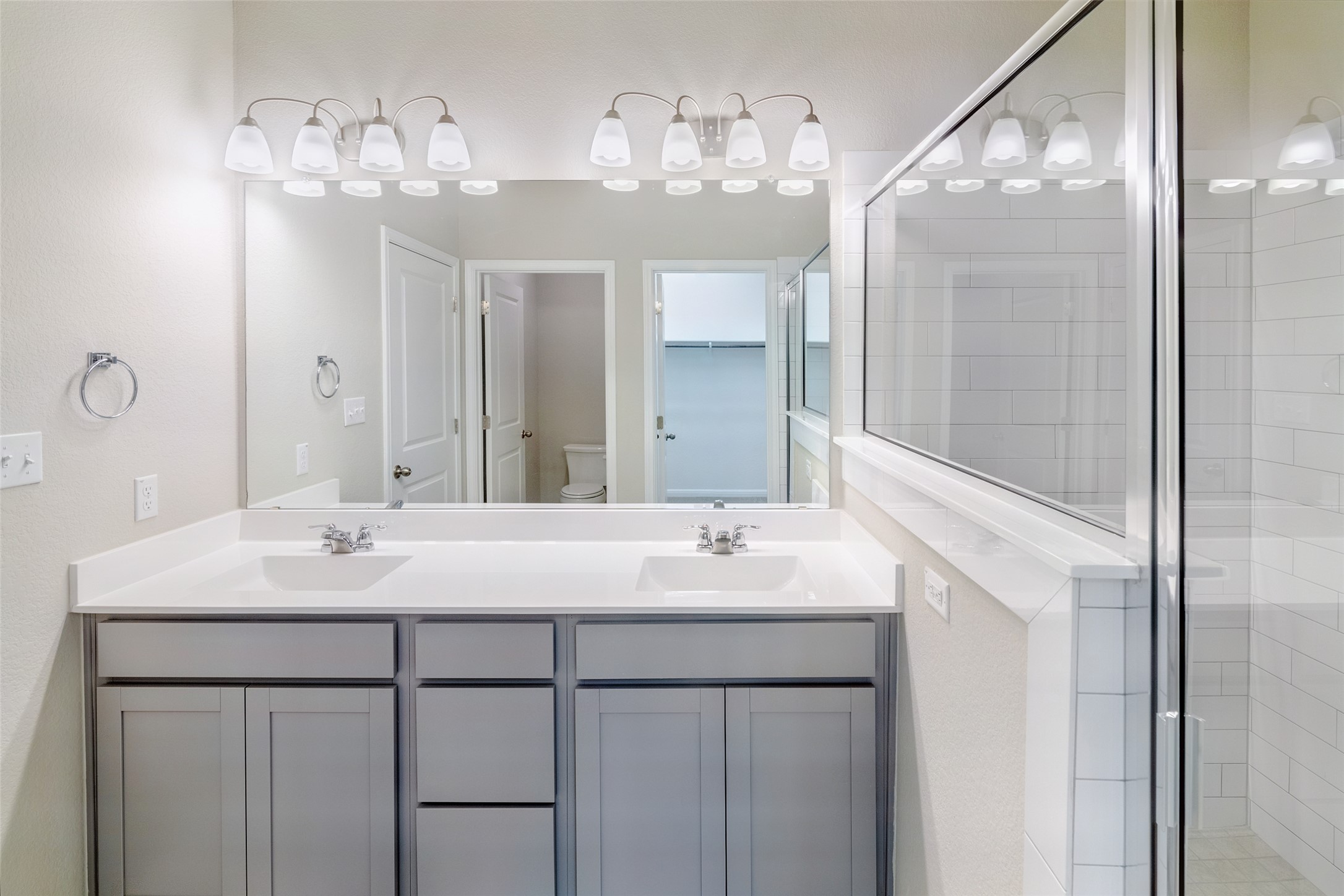 113 Watercourse Way Bastrop, TX 78602 - Photo 18 of 32 a bathroom with a sink vanity and a mirror