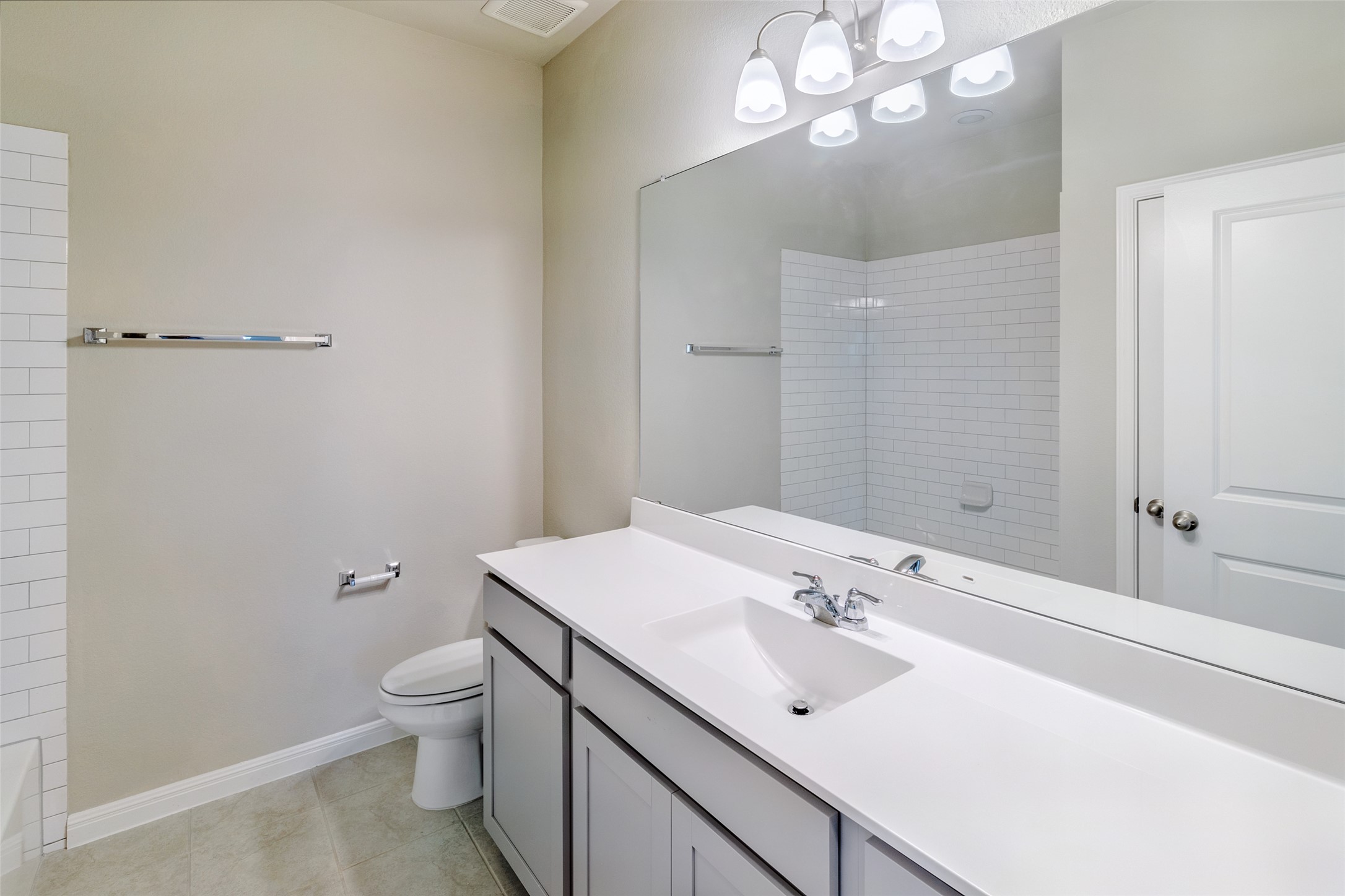 113 Watercourse Way Bastrop, TX 78602 - Photo 28 of 32 a bathroom with a sink a toilet and a mirror