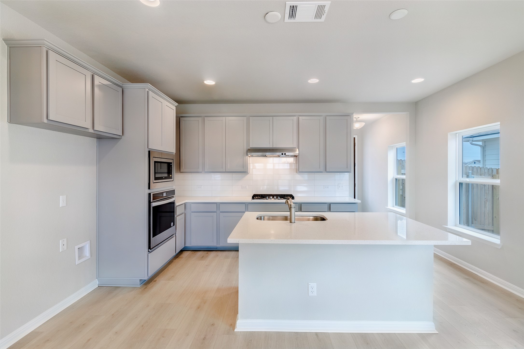 113 Watercourse Way Bastrop, TX 78602 - Photo 6 of 32 a kitchen with stainless steel appliances a refrigerator sink and stove