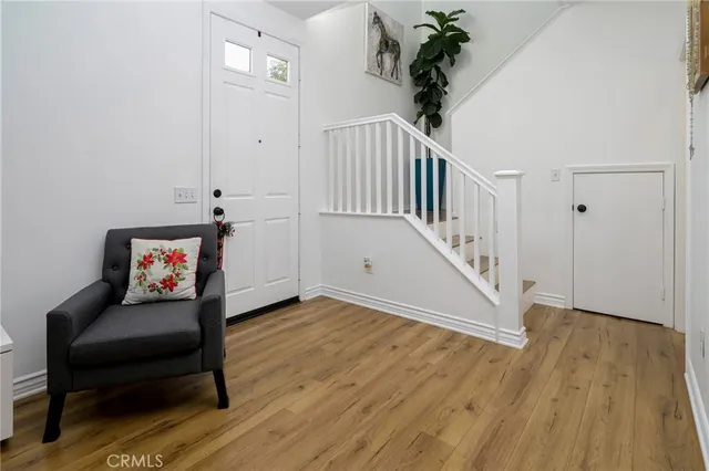 a view of a hallway with wooden floor and stairs