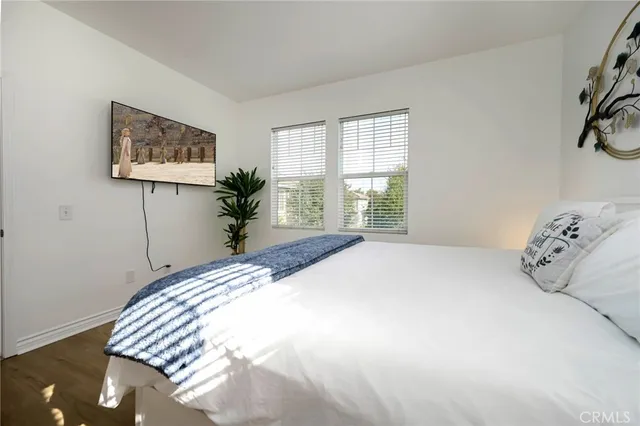a bedroom with a large bed and a window