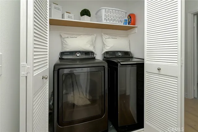 a close view of a utility room with dryer and washer