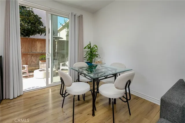 a dining room with furniture wooden floor and a potted plant