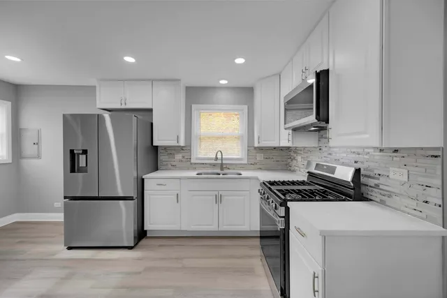 a kitchen with a refrigerator sink and microwave