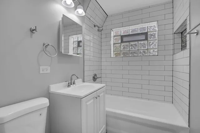 a bathroom with a bathtub a sink a toilet and a mirror