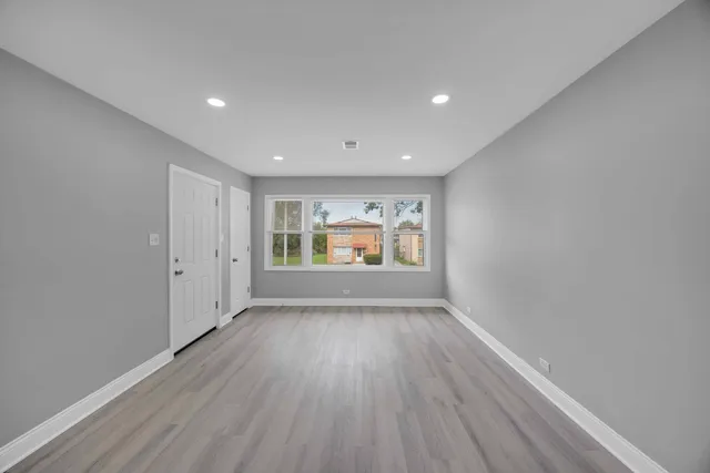 a view of room with window and wooden floor