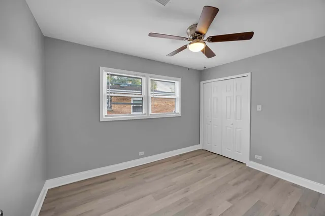 a view of room with window and ceiling fan